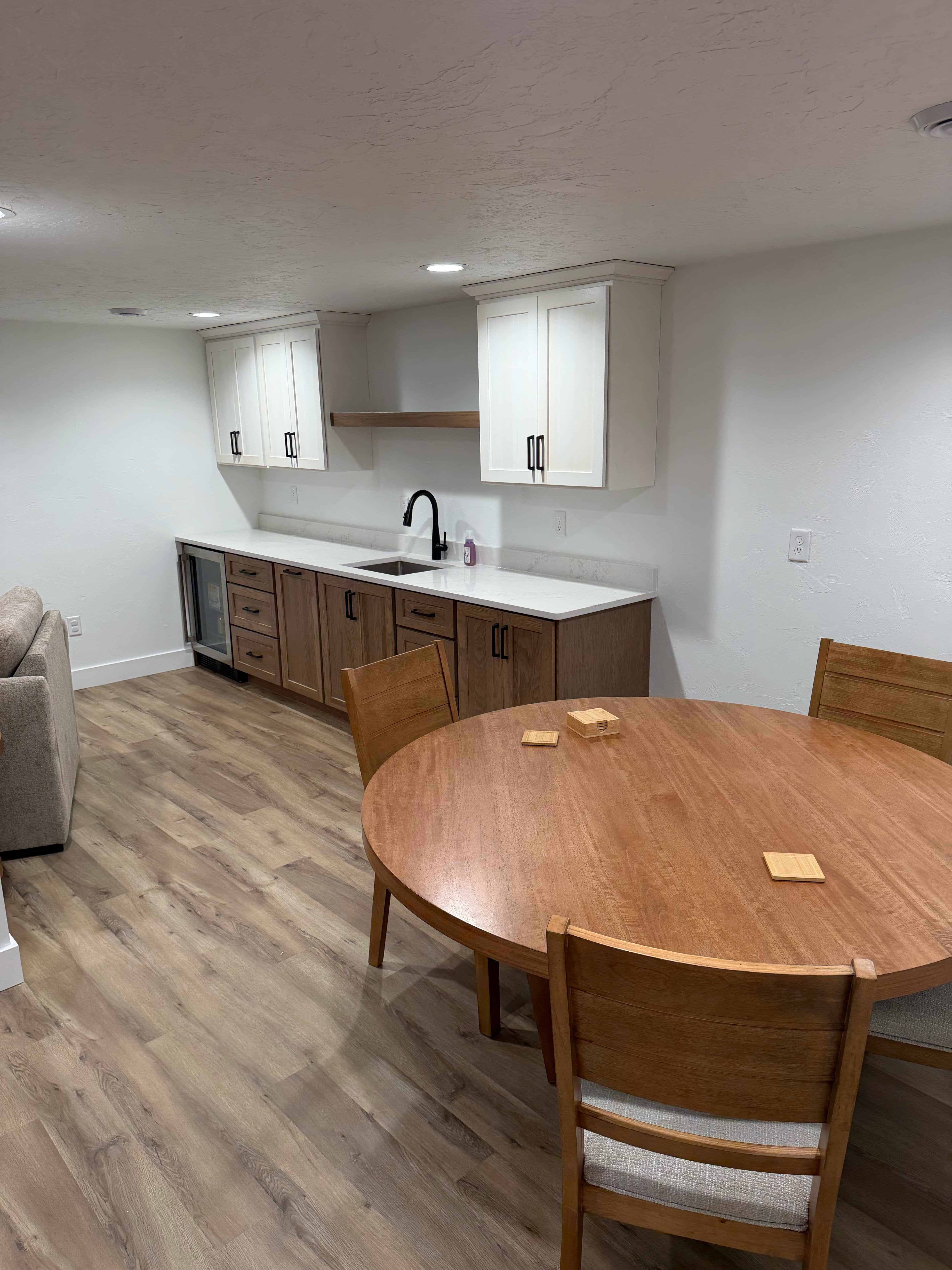Freshly painted finished basement with crisp white walls and trim by ARP Building Services in Mid-Michigan